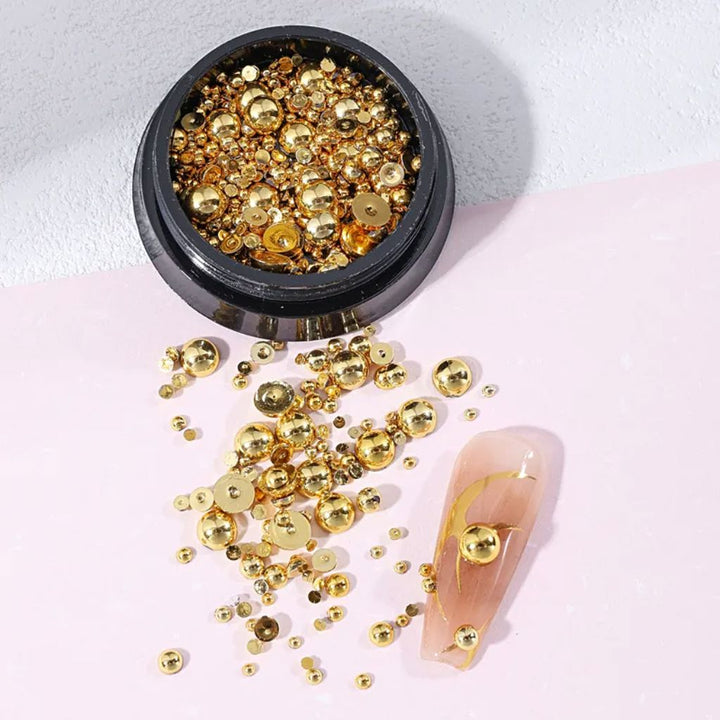 NSI Australia gold half-beads for nail art — mixed-size metallic dome studs in jar with sample nail tip