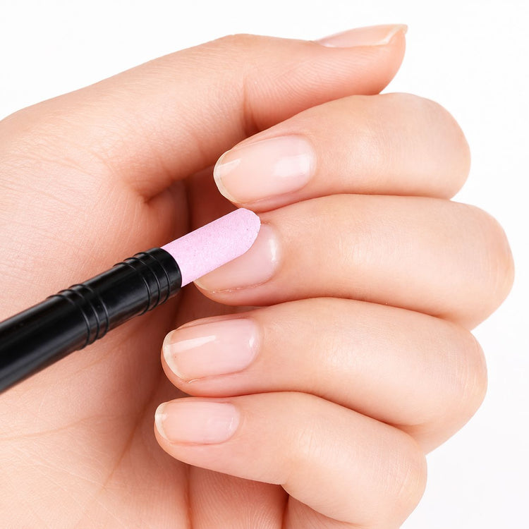 Pink stone cuticle remover tool cleaning cuticles on natural nails with black handle for smooth manicure prep