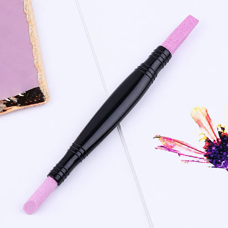Double-ended pink stone cuticle remover and nail file tool with black easy-grip handle for manicure nail prep
