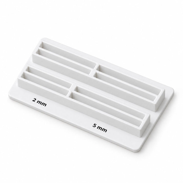 White display stand for the Nail Success Australia nail ball maker, engraved with 2 mm and 5 mm size markers