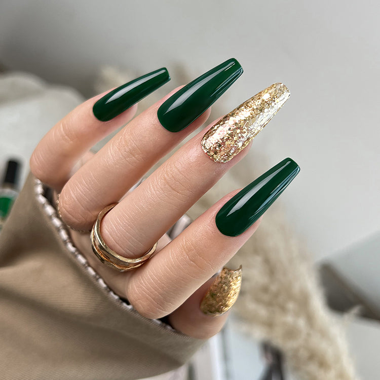 Nail Success Australia gel polish C046 in deep emerald green, shown on a model's long glossy coffin nails with a gold glitter accent nail