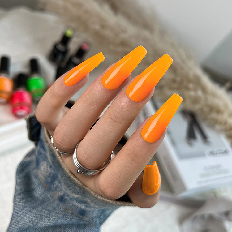 Nail Success Australia gel polish C051 in bright orange, shown on a model's long glossy coffin nails
