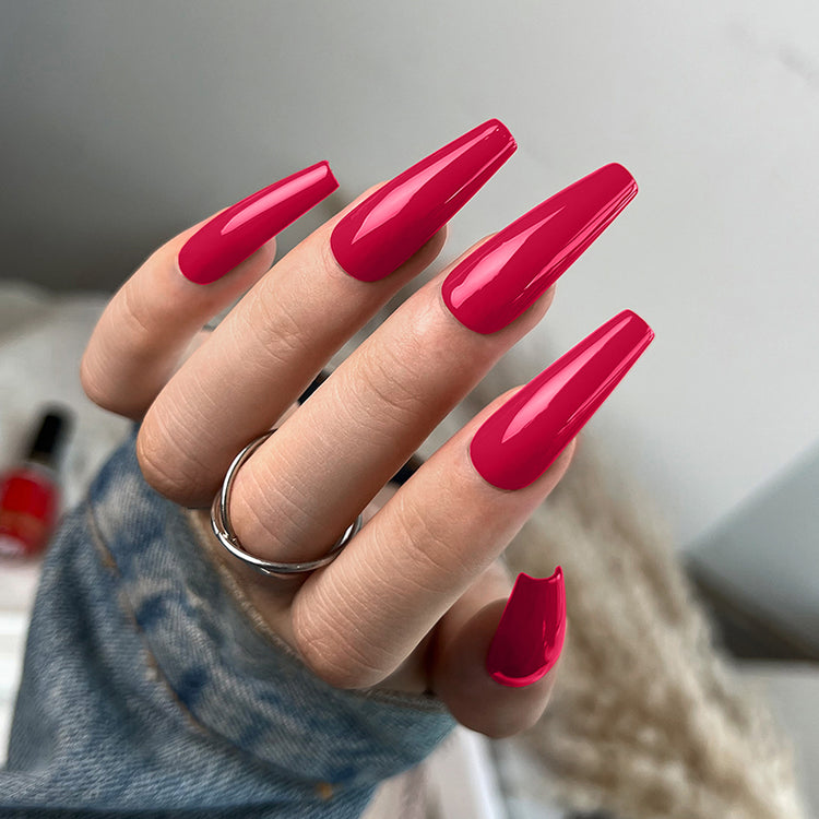 Nail Success Australia gel polish C053 in raspberry red, shown on a model's long glossy coffin nails