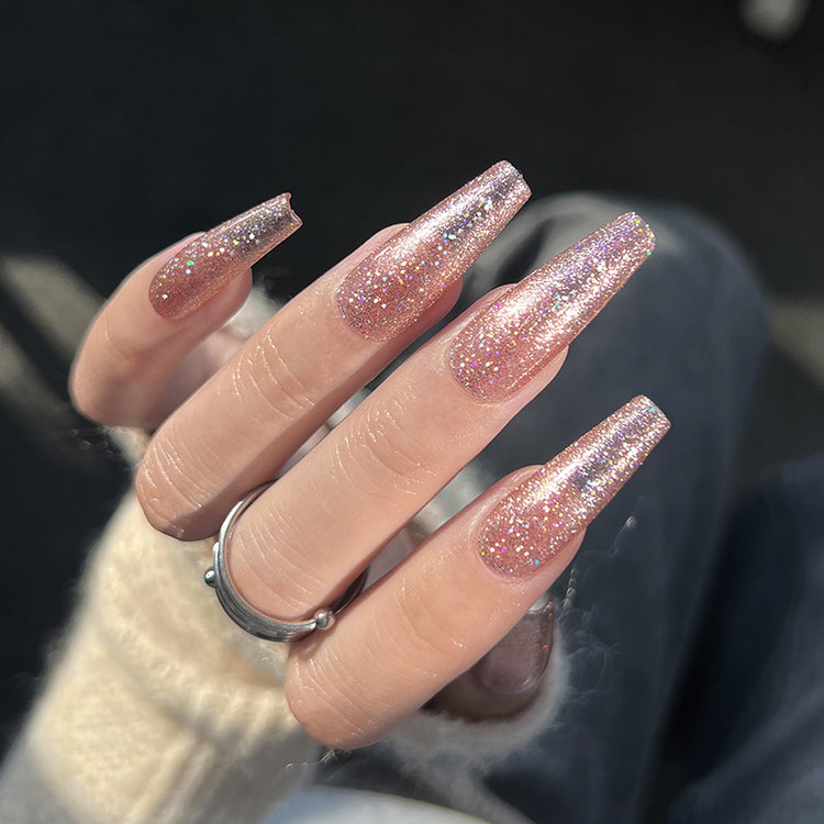 Nail Success Australia gel polish C057 in a rose gold pink holographic glitter, shown on a model's long glossy coffin nails