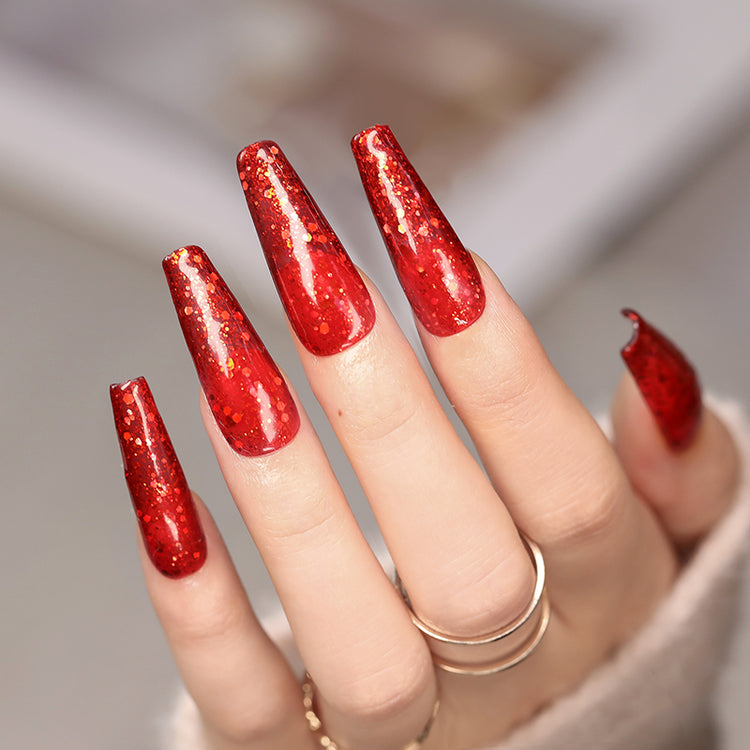 Nail Success Australia gel polish C060 in a rich red glitter, shown on a model's long glossy coffin nails