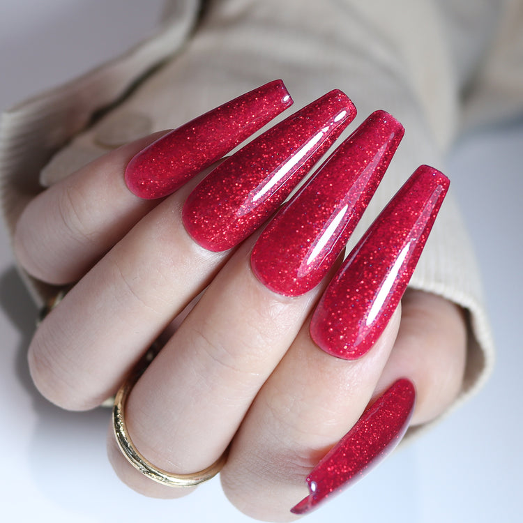 Nail Success Australia gel polish C061 in a sparkling raspberry red reflective glitter, shown on a model's long glossy coffin nails