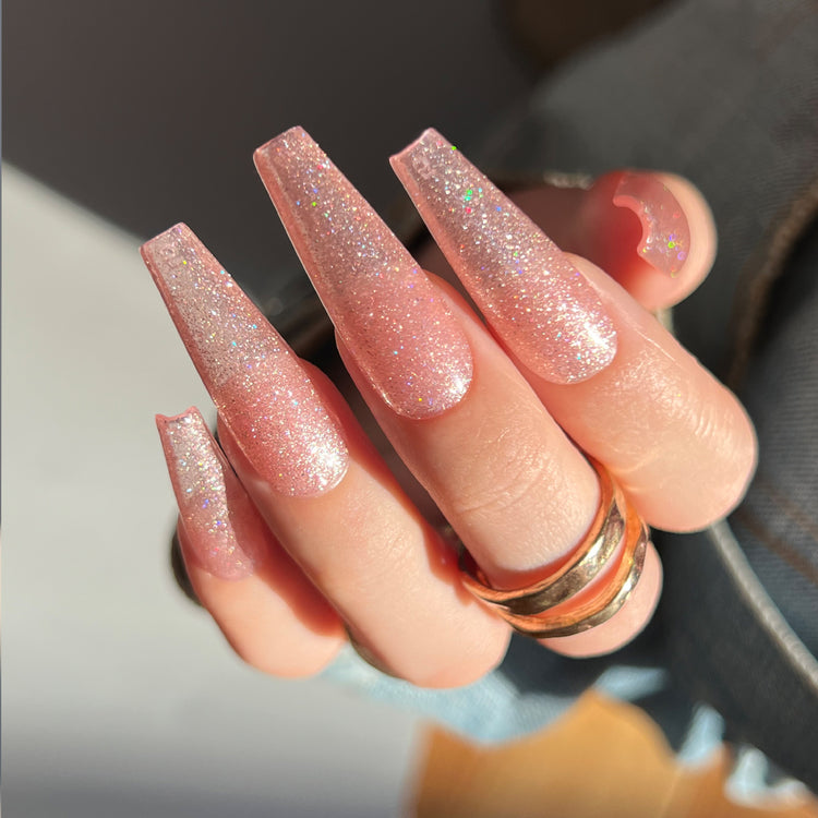Nail Success Australia gel polish C062 in a rose gold champagne reflective glitter, shown on a model's long glossy coffin nails