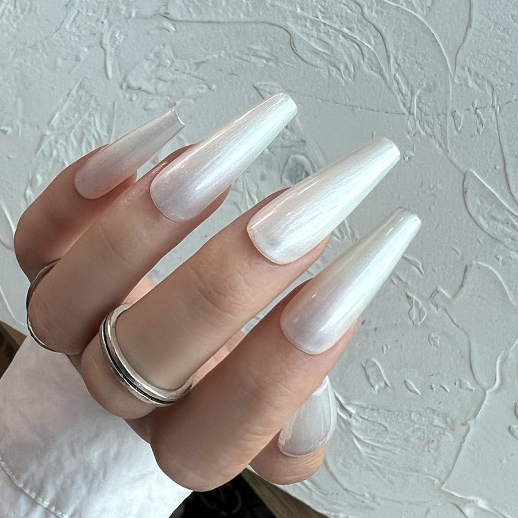 Nail Success Australia gel polish C064 in an icy white pearl shimmer, shown on a model's long glossy coffin nails