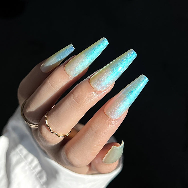 Nail Success Australia gel polish C066 in a pearl white with aqua-green aurora shimmer, shown on a model's long glossy coffin nails