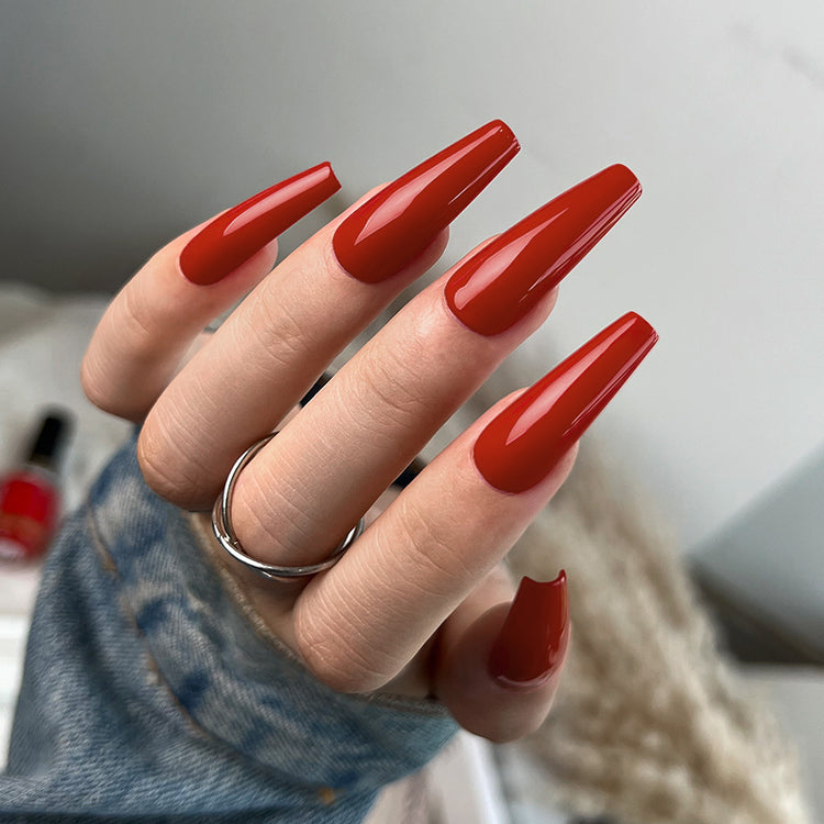 Nail Success Australia gel polish C068 in a warm brick red, shown on a model's long glossy coffin nails