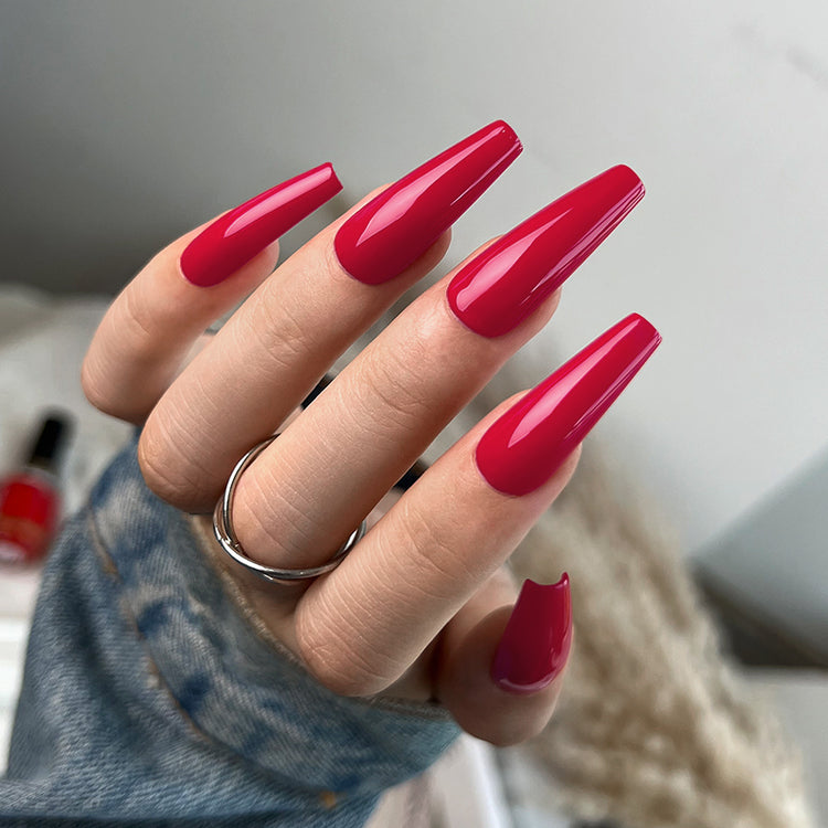Nail Success Australia gel polish C069 in a vivid raspberry red, shown on a model's long glossy coffin nails