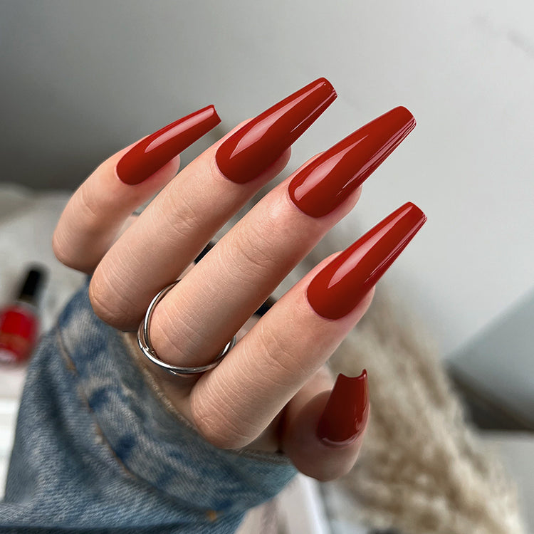 Nail Success Australia gel polish C072 in a terracotta rust red, shown on a model's long glossy coffin nails