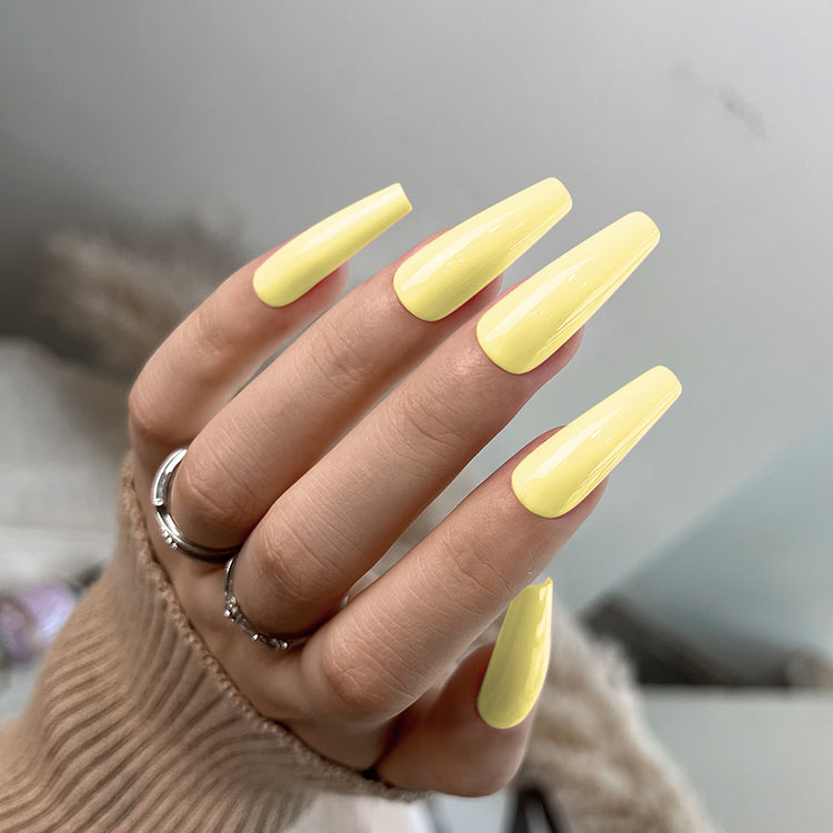 Nail Success Australia gel polish C073 in a soft pastel butter yellow, shown on a model's long glossy coffin nails