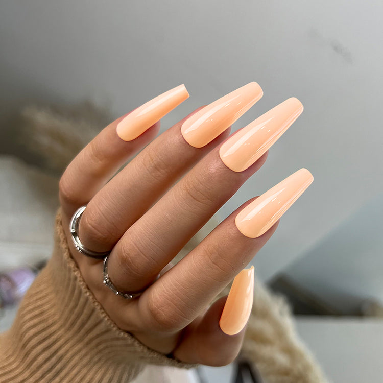 Nail Success Australia gel polish C075 in a soft pastel peach, shown on a model's long glossy coffin nails