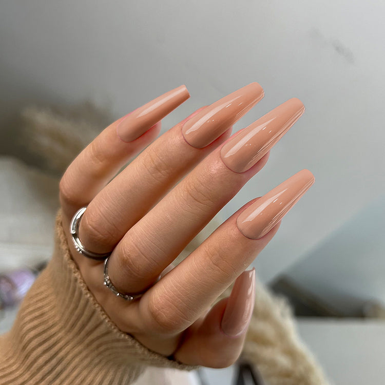 Nail Success Australia gel polish C076 in a nude beige, shown on a model's long glossy coffin nails