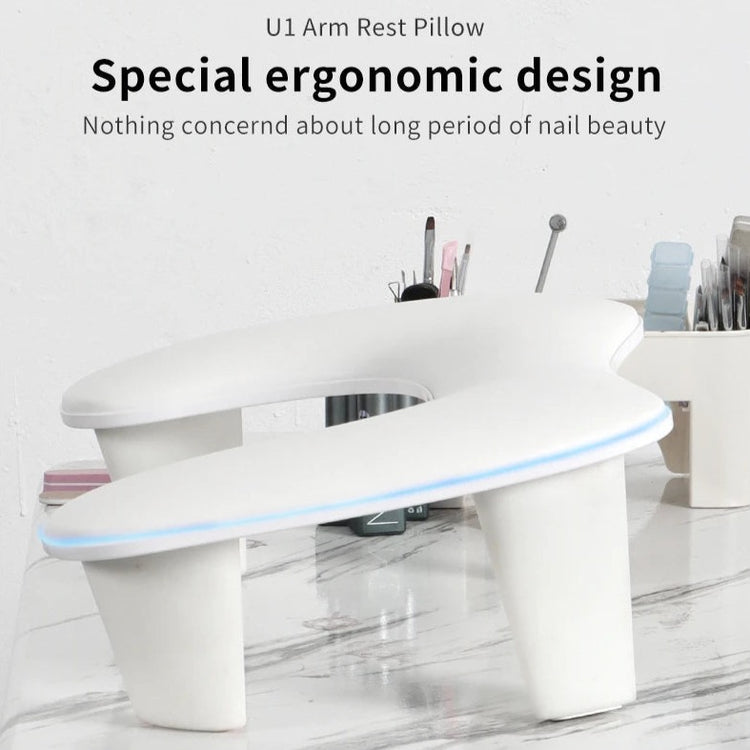 Nail Success Australia U1 manicure arm rest pillow with a special ergonomic design, a white cushion with a soft blue LED-lit edge and nail tools in the background