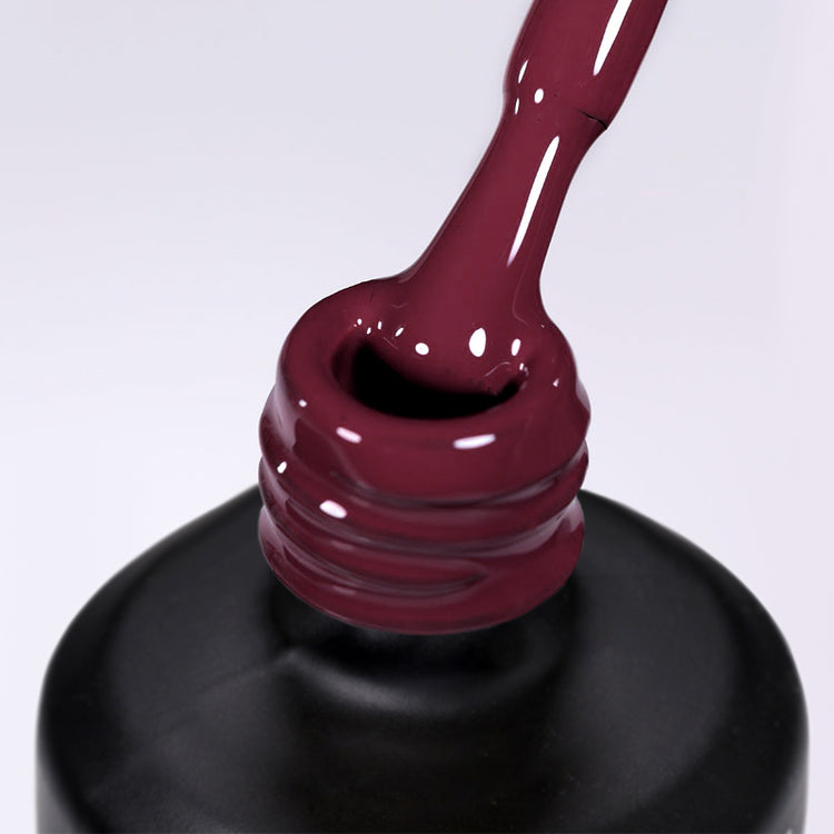 Nail Success Australia gel polish in deep wine burgundy, shown as a glossy brush drip over the black bottle
