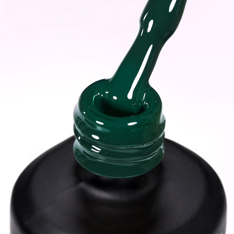 Nail Success Australia gel polish C046 in deep emerald green, a close-up of the brush lifting from the bottle neck showing the creamy dark green colour