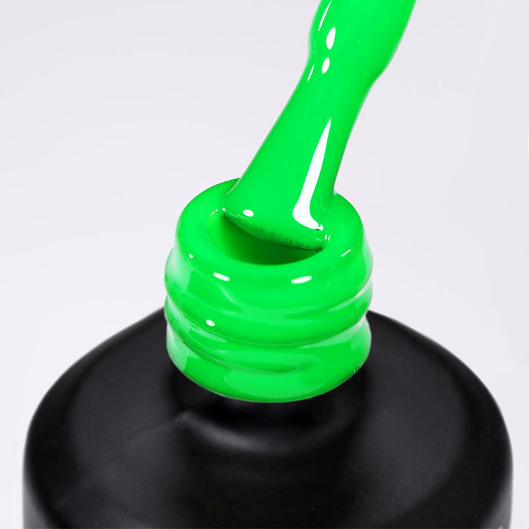 Nail Success Australia gel polish C048 in bright neon green, a close-up of the brush lifting from the bottle neck showing the creamy green colour
