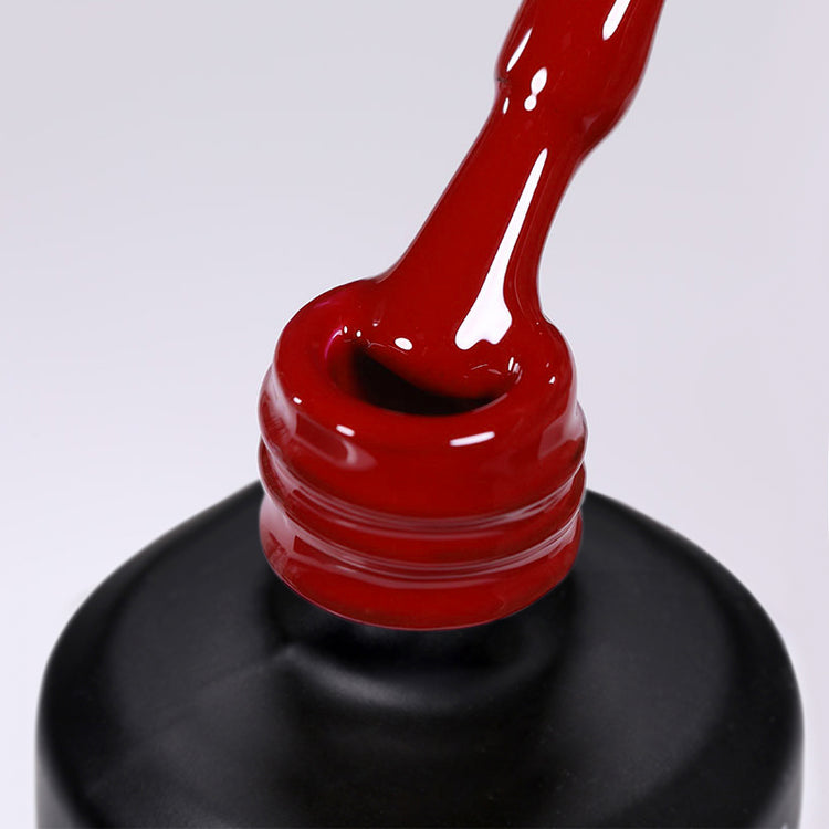 Nail Success Australia gel polish C070 in a classic true red, a close-up of the brush lifting from the bottle neck showing the creamy colour