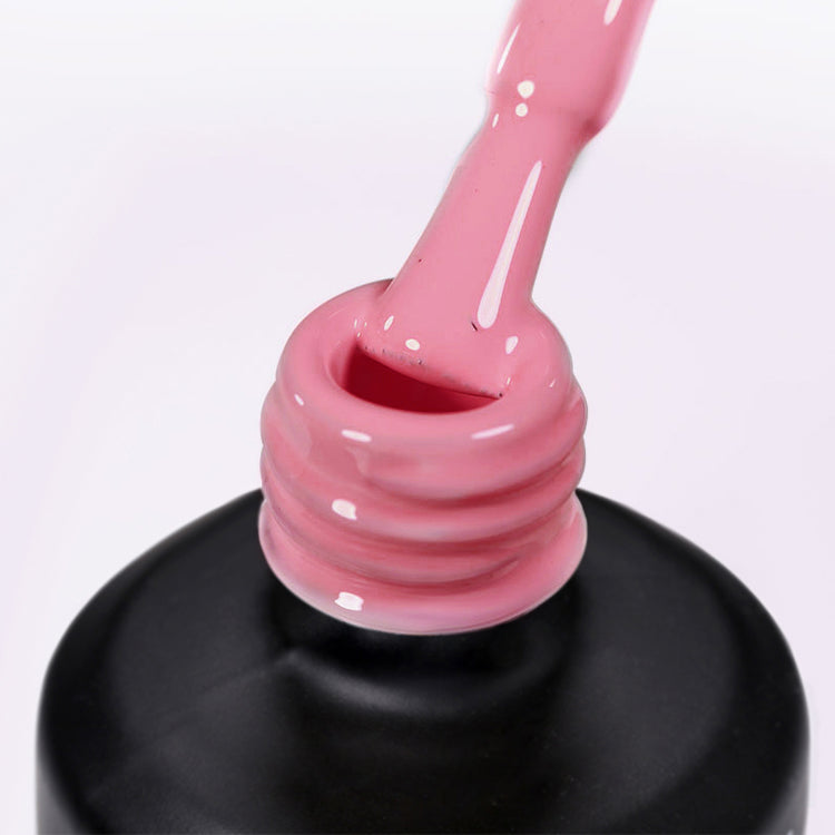 Nail Success Australia gel polish C082 in a coral salmon pink, a close-up of the brush lifting from the bottle neck showing the creamy colour
