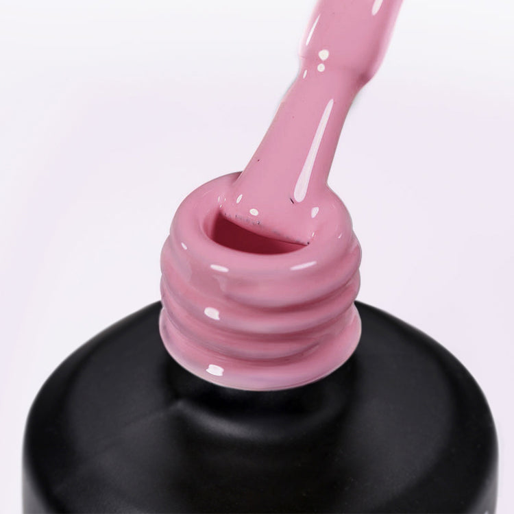 Nail Success Australia gel polish C084 in a dusty rose pink, a close-up of the brush lifting from the bottle neck showing the creamy colour