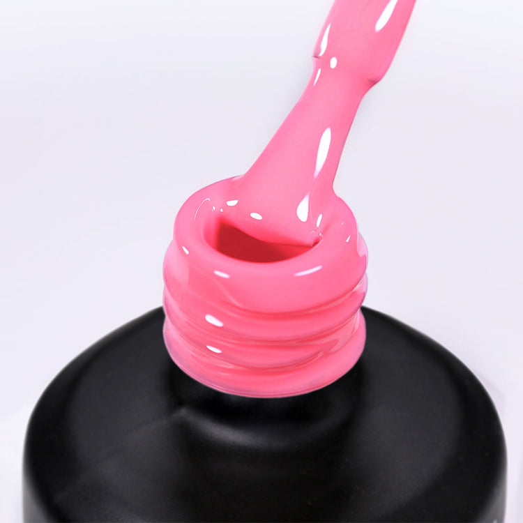 Nail Success Australia gel polish C085 in a bright candy pink, a close-up of the brush lifting from the bottle neck showing the creamy colour