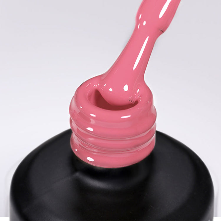 Nail Success Australia gel polish C086 in a muted dusty rose, a close-up of the brush lifting from the bottle neck showing the creamy colour