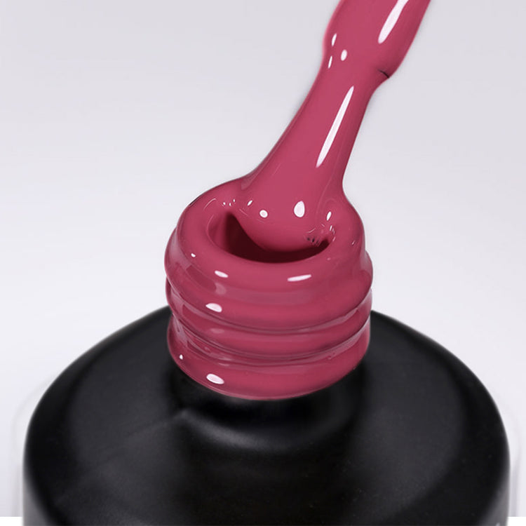 Nail Success Australia gel polish C087 in a deep berry rose, a close-up of the brush lifting from the bottle neck showing the creamy colour