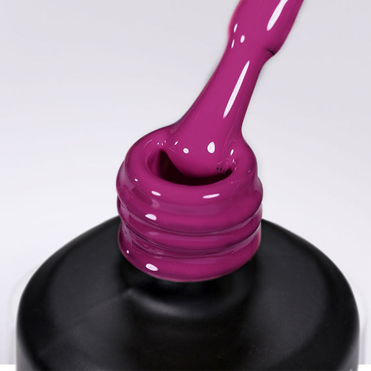 Nail Success Australia gel polish C090 in a bright magenta fuchsia, a close-up of the brush lifting from the bottle neck showing the creamy colour