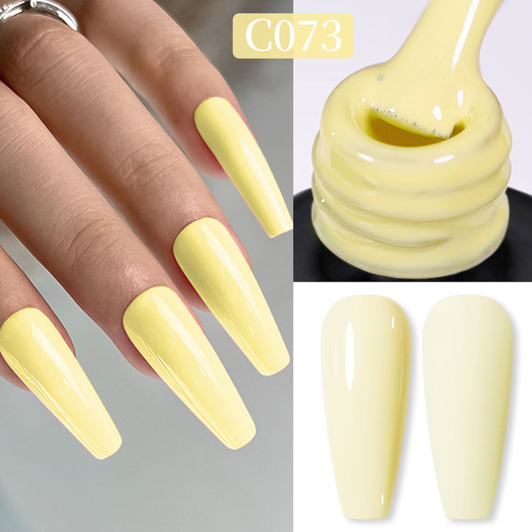 Nail Success Australia gel polish C073 in a soft pastel butter yellow, shown on a model's long glossy coffin nails alongside the bottle and gloss and matte swatch tips