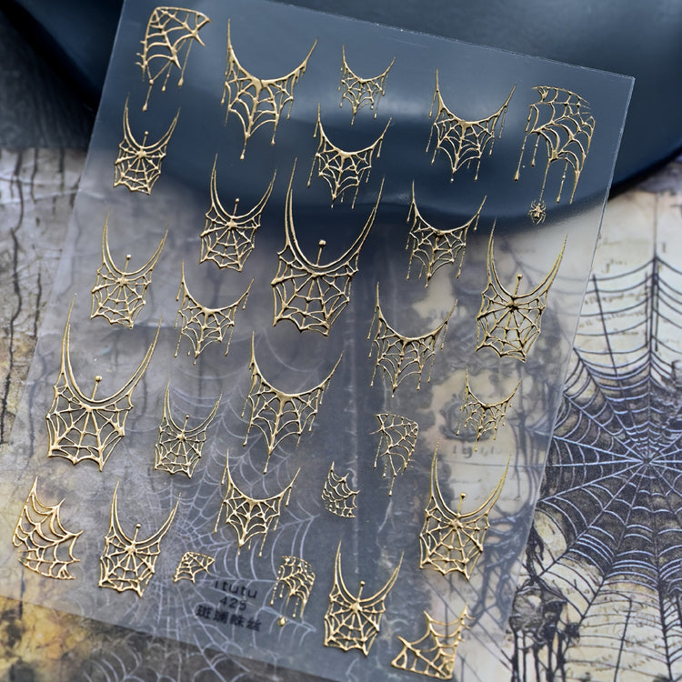 Spider web gold nail art sticker for French, sheet of webs on a cobweb-print backdrop