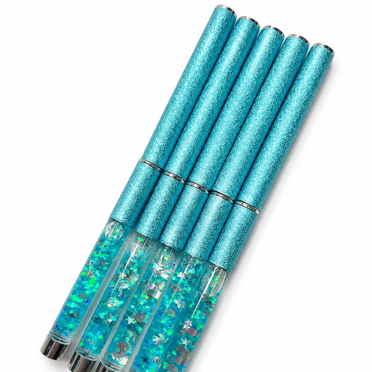 Acrylic nail brush set with blue glitter crystal handles shown capped with turquoise textured caps for professional nail application and storage