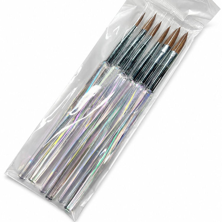 Acrylic nail brush set with clear aurora crystal handles, silver ferrules and pointed brown bristles displayed in clear protective packaging