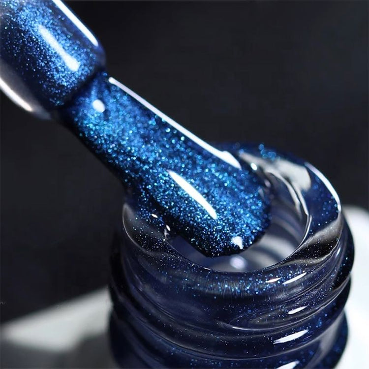 Blue Tears aurora cat eye gel polish texture close-up on brush with sparkling blue shimmer