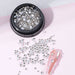 NSI Australia clear nail art rhinestones — mixed-size flatback crystals in jar with sample pink nail tip