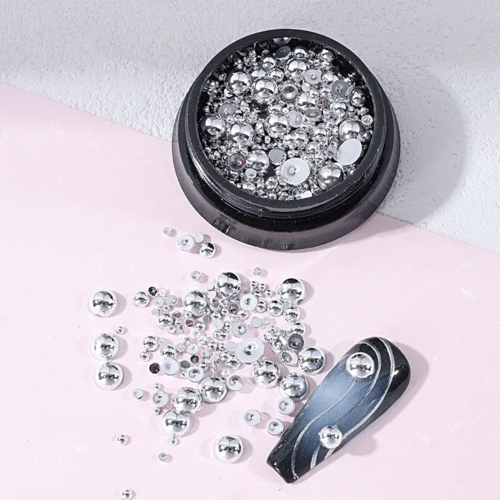 NSI Australia silver half-beads for nail art — mixed-size metallic dome studs in jar with sample nail tip