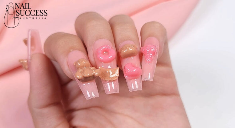 Long square pink jelly nails with 3D teddy bear, donut and heart gel charms — Nail Success Australia