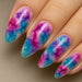 NSI Blooming Gel watercolor marble almond nails — glossy pink, purple and teal gradient smoke effect close-up on hand