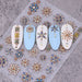 Bohemian 5D gemstone embossed nail art stickers with blue and gold floral designs on sample nail tips for luxury salon manicure decorations