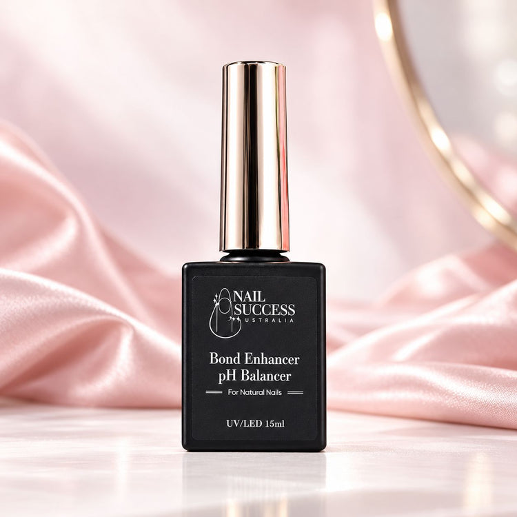 Bond Enhancer pH Balancer 15ml black bottle with gold cap on pink satin