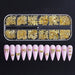 Gold nail art charms mix in clear compartment tray with pink nail tip display, 3D metal bow and ribbon decorations