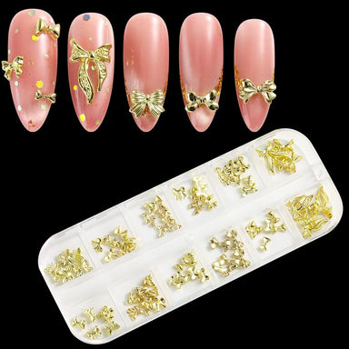 Gold bowknot 3D nail art charms set in organizer tray, with pink nail tips showing bow designs