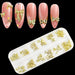 Gold bowknot 3D nail art charms set in organizer tray, with pink nail tips showing bow designs