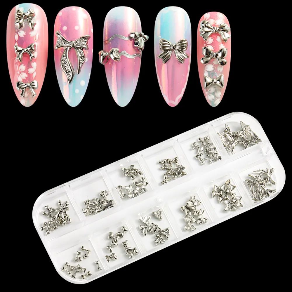 Silver nail art charms set in clear compartment tray with 3D metal bow and ribbon decorations, shown on pink nail tips