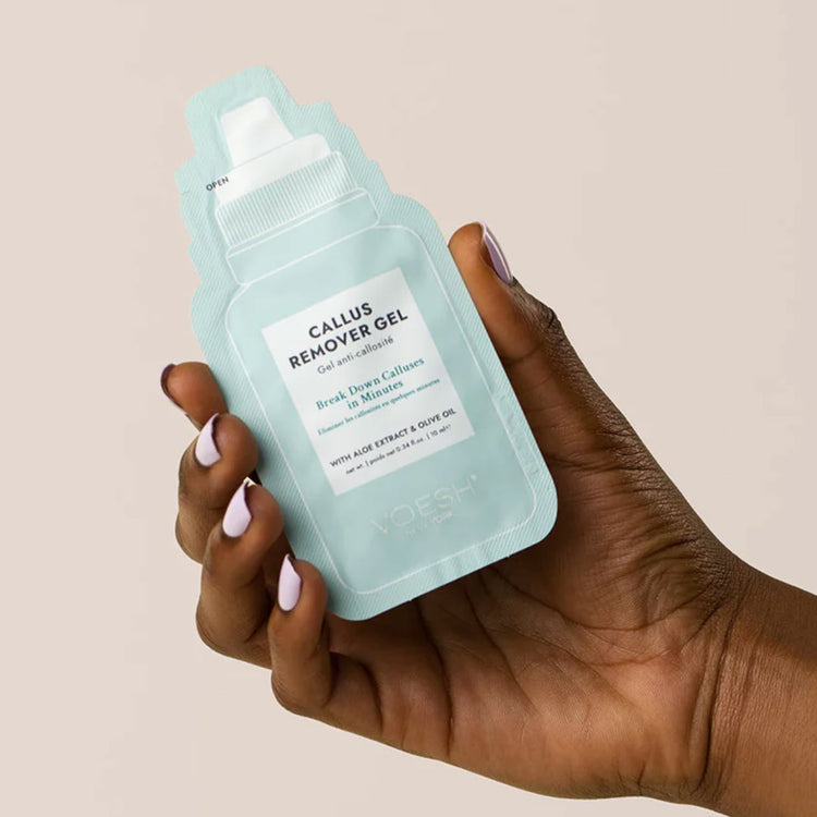 Hand holding VOESH New York Callus Remover Gel sachet with aloe extract and olive oil for pedicure care