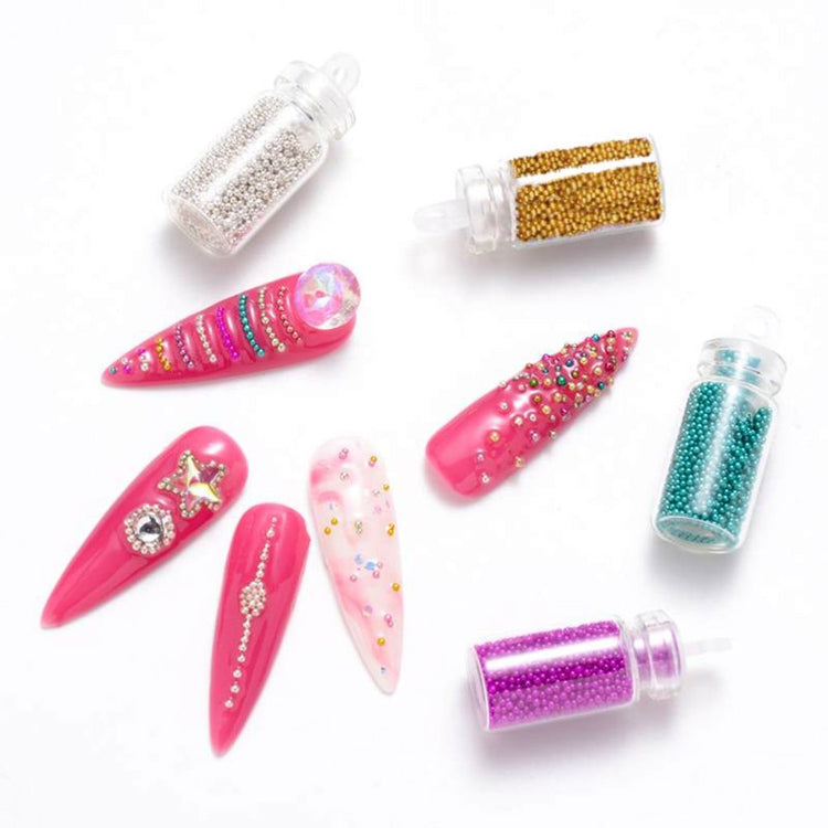Caviar nail art beads on pink sample tips with rhinestones; microbead bottles in silver, gold, teal and purple