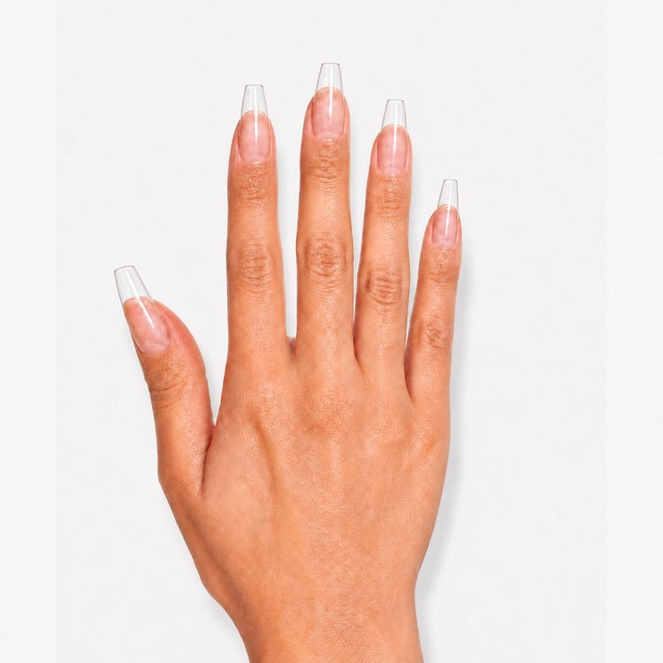 Hand wearing clear NSI Coffin Nail Tips applied over the natural nail