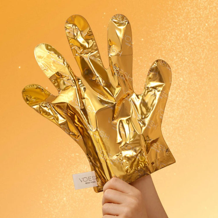 VOESH Imperial Gold Collagen Gloves hand mask product image with gold treatment gloves on shimmering gold background