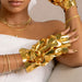 Close-up lifestyle image of VOESH Imperial Gold Collagen Gloves hand mask in use with gold manicure and spa-style styling